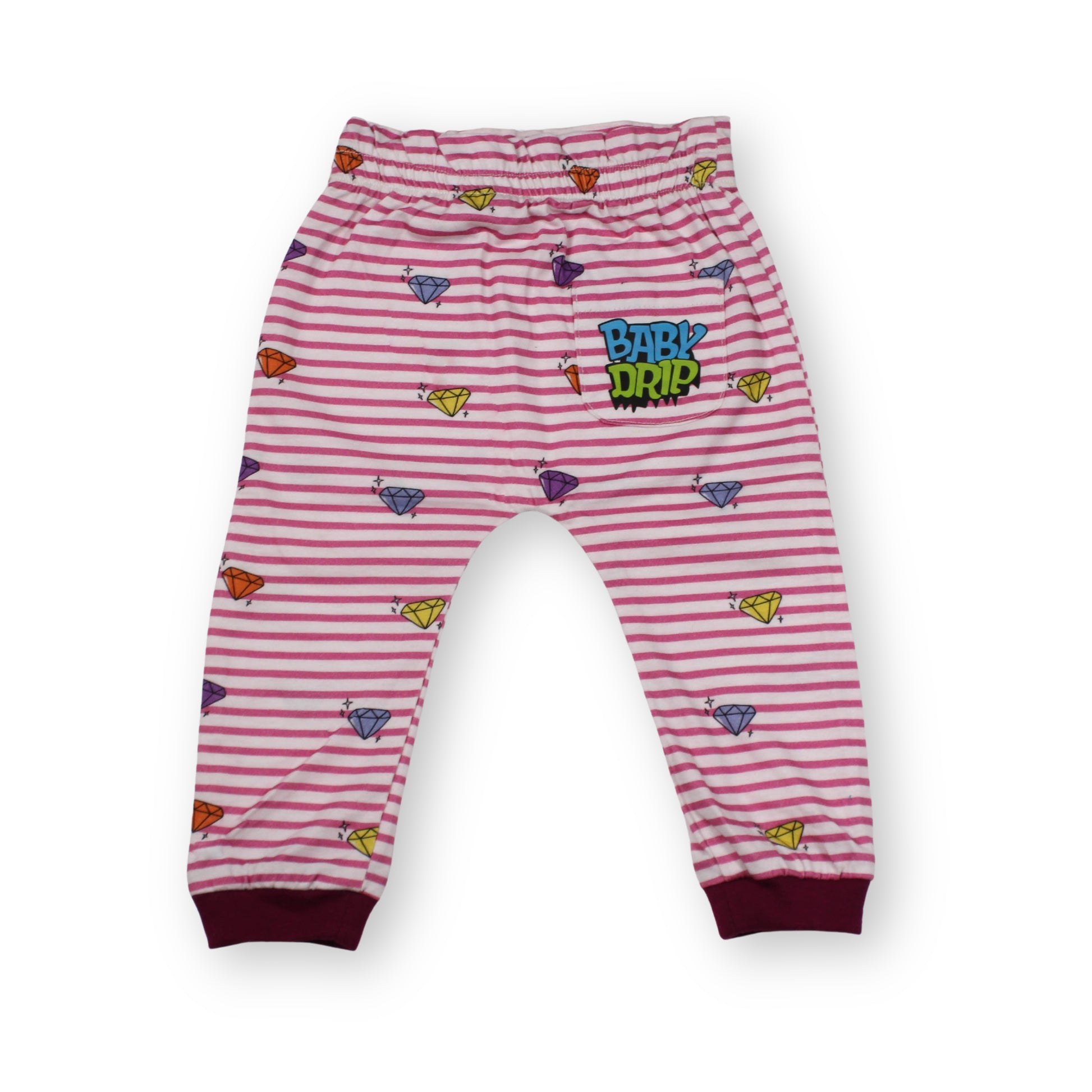 A Babydrip Pink and white striped baby girl pants with colorful baby drip diamond motifs, magenta colored ribbed cuffs and the 'BABY Drip' logo on the back pocket on the right side of the pants, laid out against a plain white background.