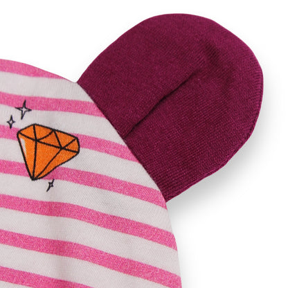 A close up image of a Babydrip Beanie with bunny ears in dark magenta color and pink and white striped highlighting a colorful diamond graphic print motif laid out on a white background.