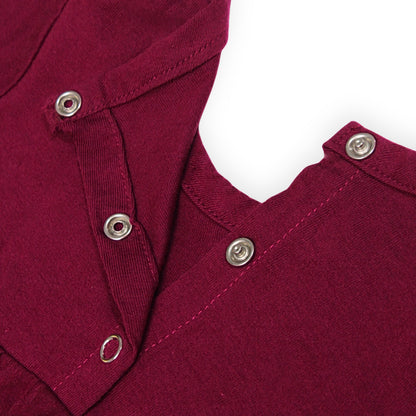Close-up of a Babydrip Magenta Tunic Blouse neckline with silver metal snap open and shut buttons along the neckline, shown laying flat against a white background.