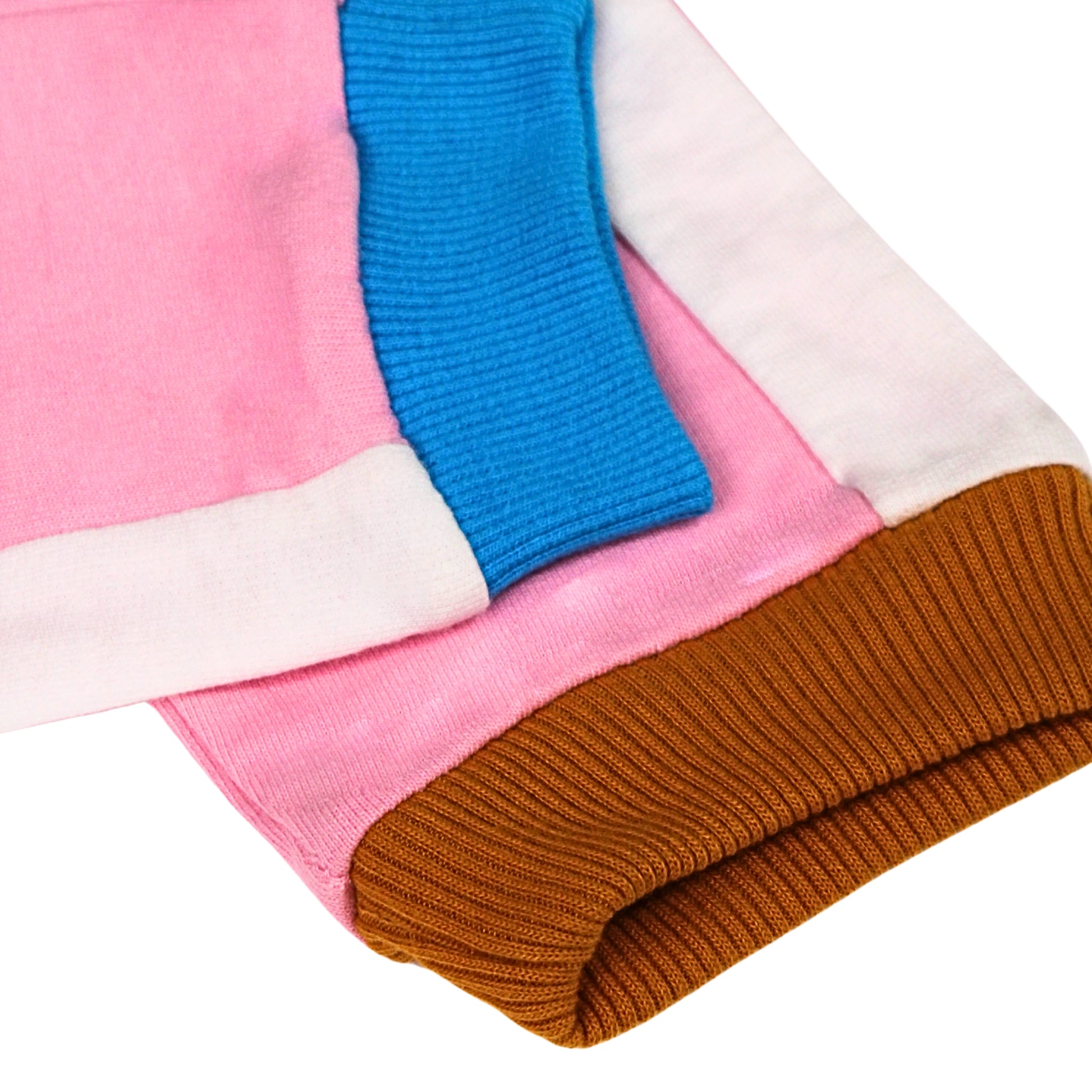 Close up image of a Babydrip folded terry cotton pants cuff with color-blocked sections in pink, bright blue ribbed cuff, white side panels and brown ribbed cuff, shown on a plain white background.