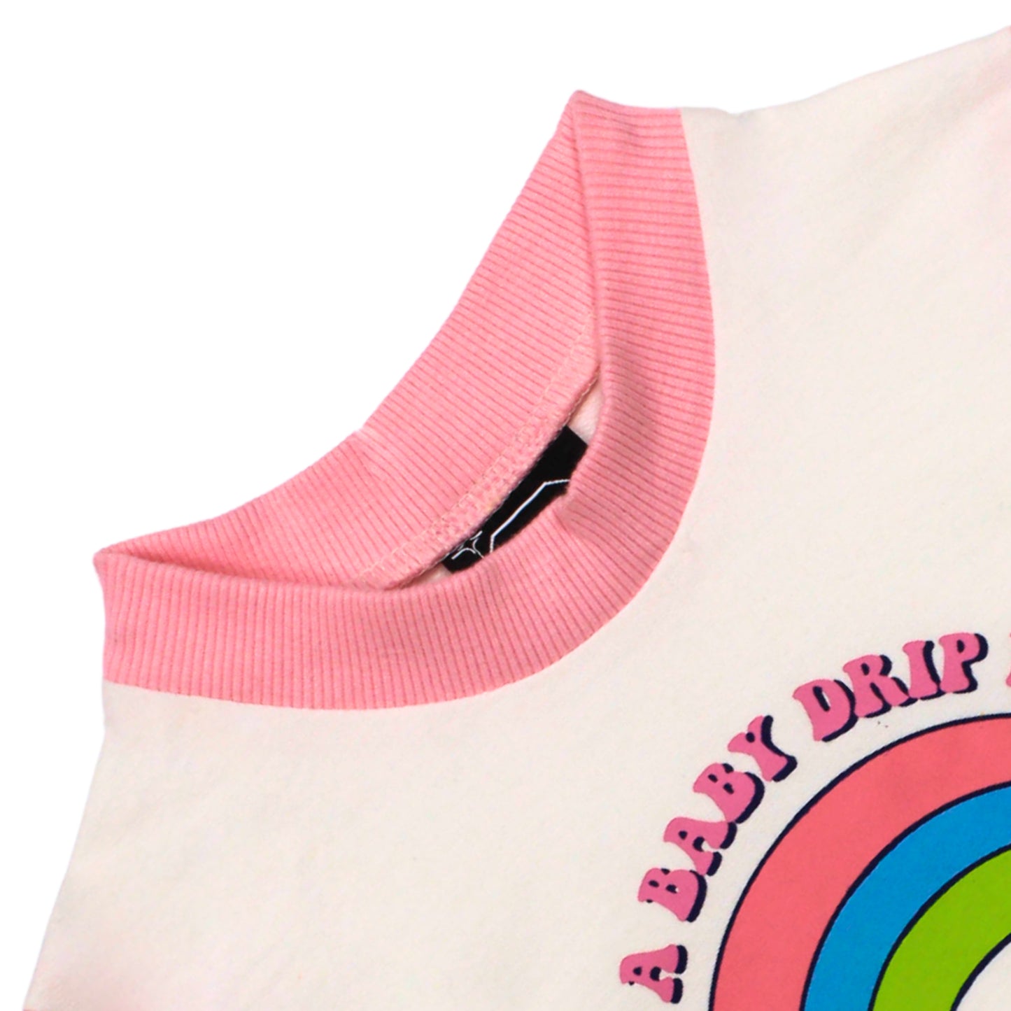 Close-up image of Babydrip terry cotton-styled Sweatshirt showing a light pink ribbed crew neck on a white body with a colorful graphic print of a rainbow and the text 'A BABY DRIP' laid out on a white background.