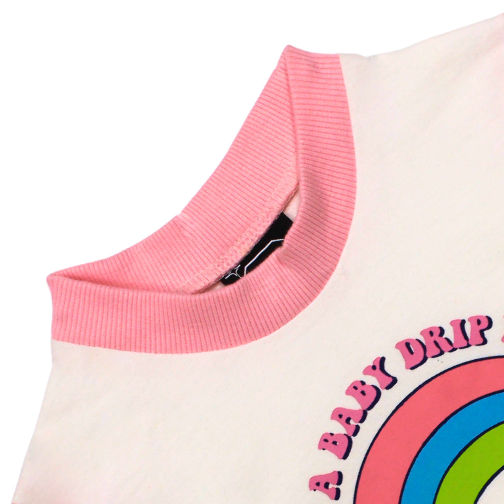 Close-up image of Babydrip terry cotton-styled Sweatshirt showing a light pink ribbed crew neck on a white body with a colorful graphic print of a rainbow and the text 'A BABY DRIP' laid out on a white background.