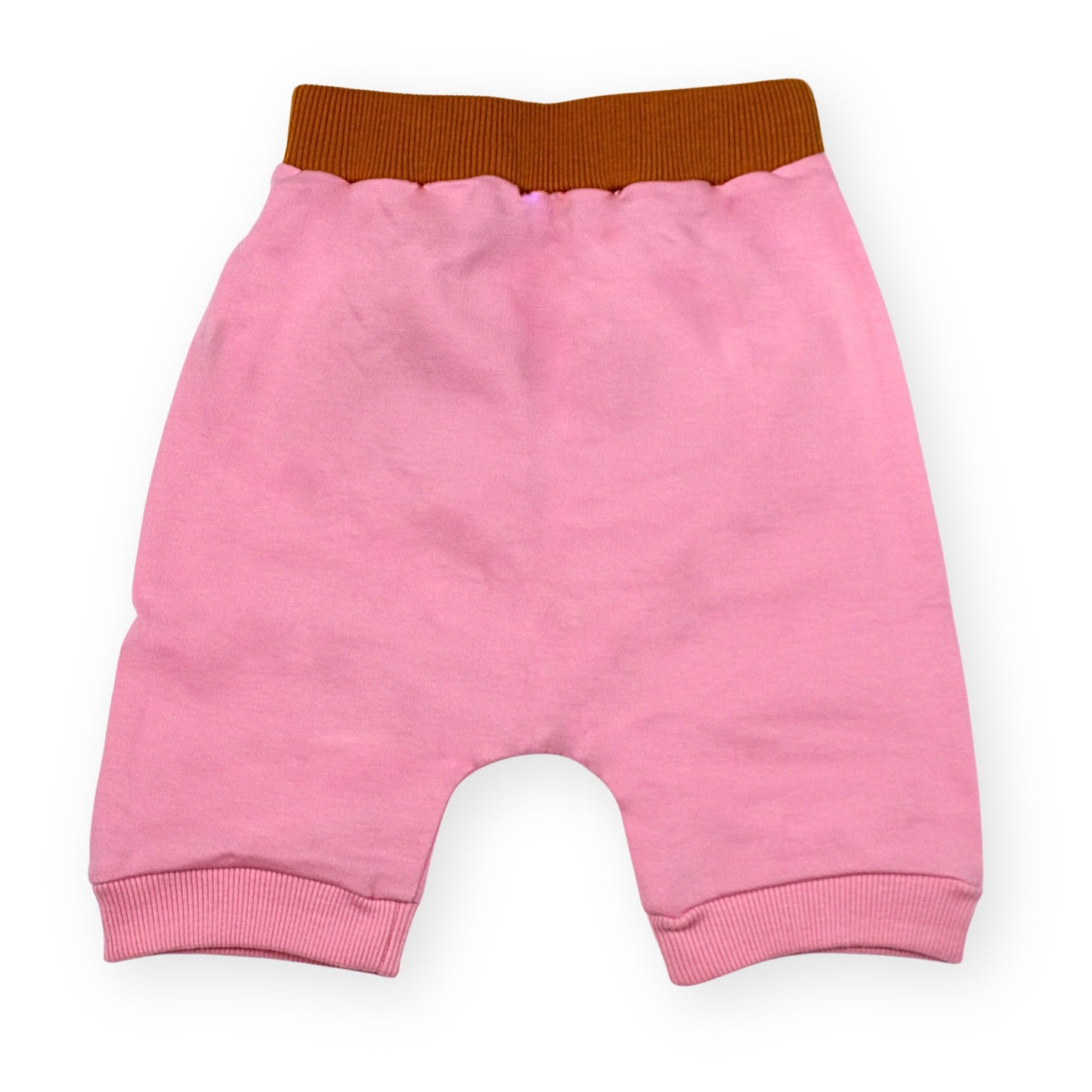 A Babydrip girls sweat shorts Image showing the back of the Pink terry cotton shorts with a brown elastic waistband and pink ribbed cuffs, laid flat on a white background.
