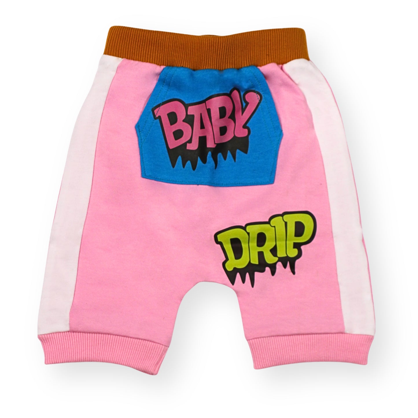 A Babydrip Pink girl's sweat shorts with white side panels, brown ribbed waistband and pink cuffs, with a blue Kangaroo pocket patch at the center in the front with pink graphics 'BABY' text, with black outline and a green 'DRIP' graphic text with black outline further down from the pocket, shown laying flat on a white background.