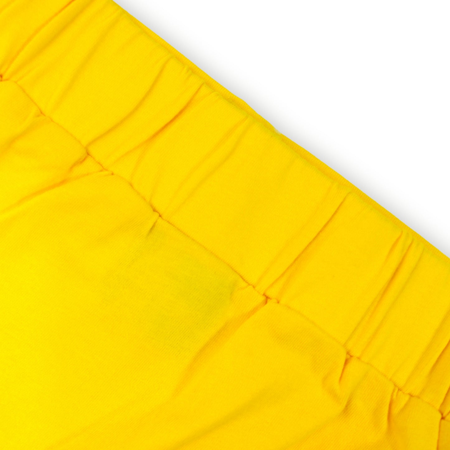 Close-up image of babydrip bright yellow fabric with a gathered elastic waistband, shown against a white background.