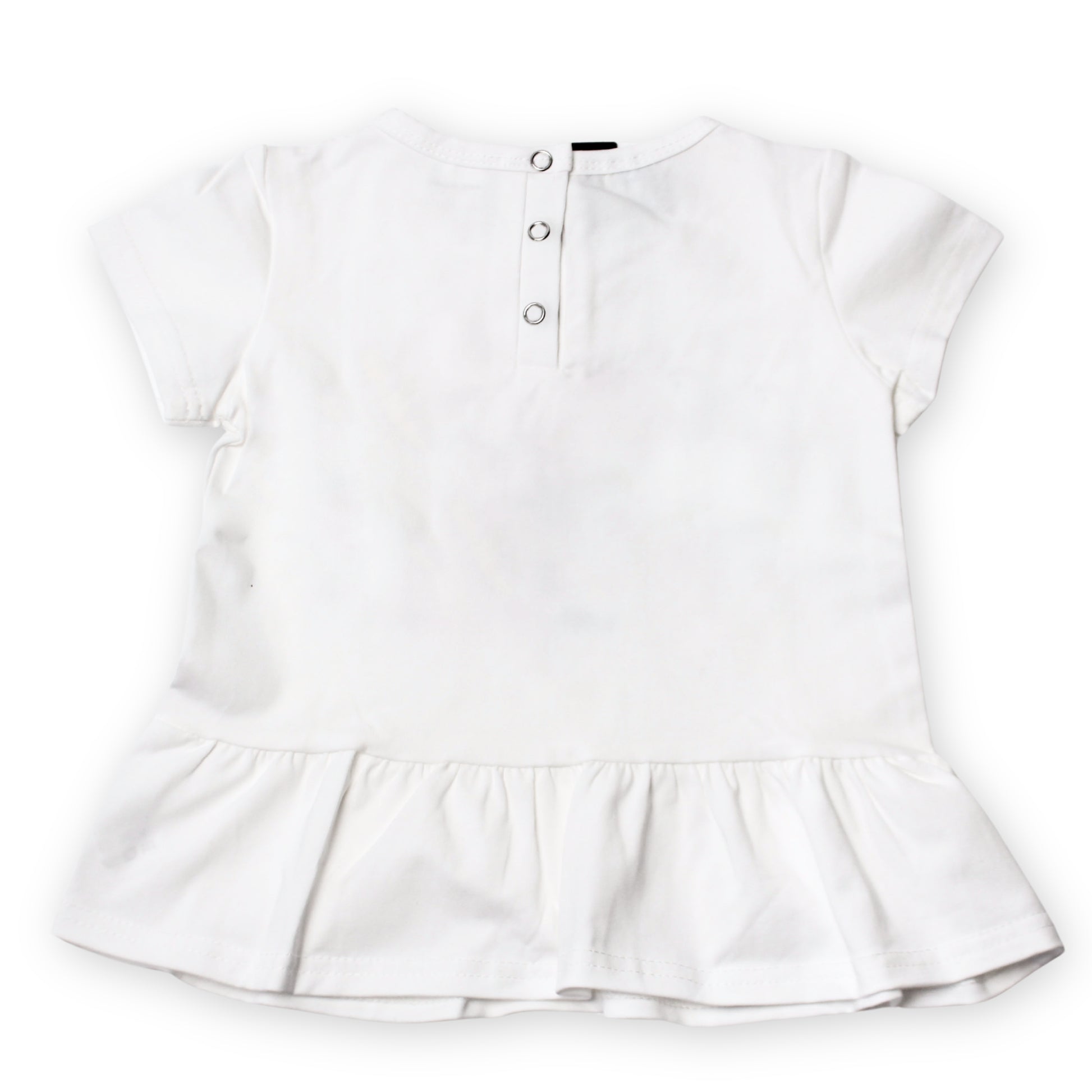 The back image of a white short-sleeve baby top rom the babydrip collection with a ruffled hem and three-button snap open and shut at the back, shown flat on a white background.