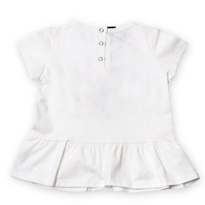 The back image of a white short-sleeve baby top rom the babydrip collection with a ruffled hem and three-button snap open and shut at the back, shown flat on a white background.