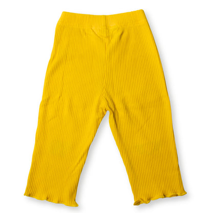 Image of the back section of a Babydrip bright yellow ribbed knit pants with a wide elastic waistband and ruffled hems, shown flat against a white background.