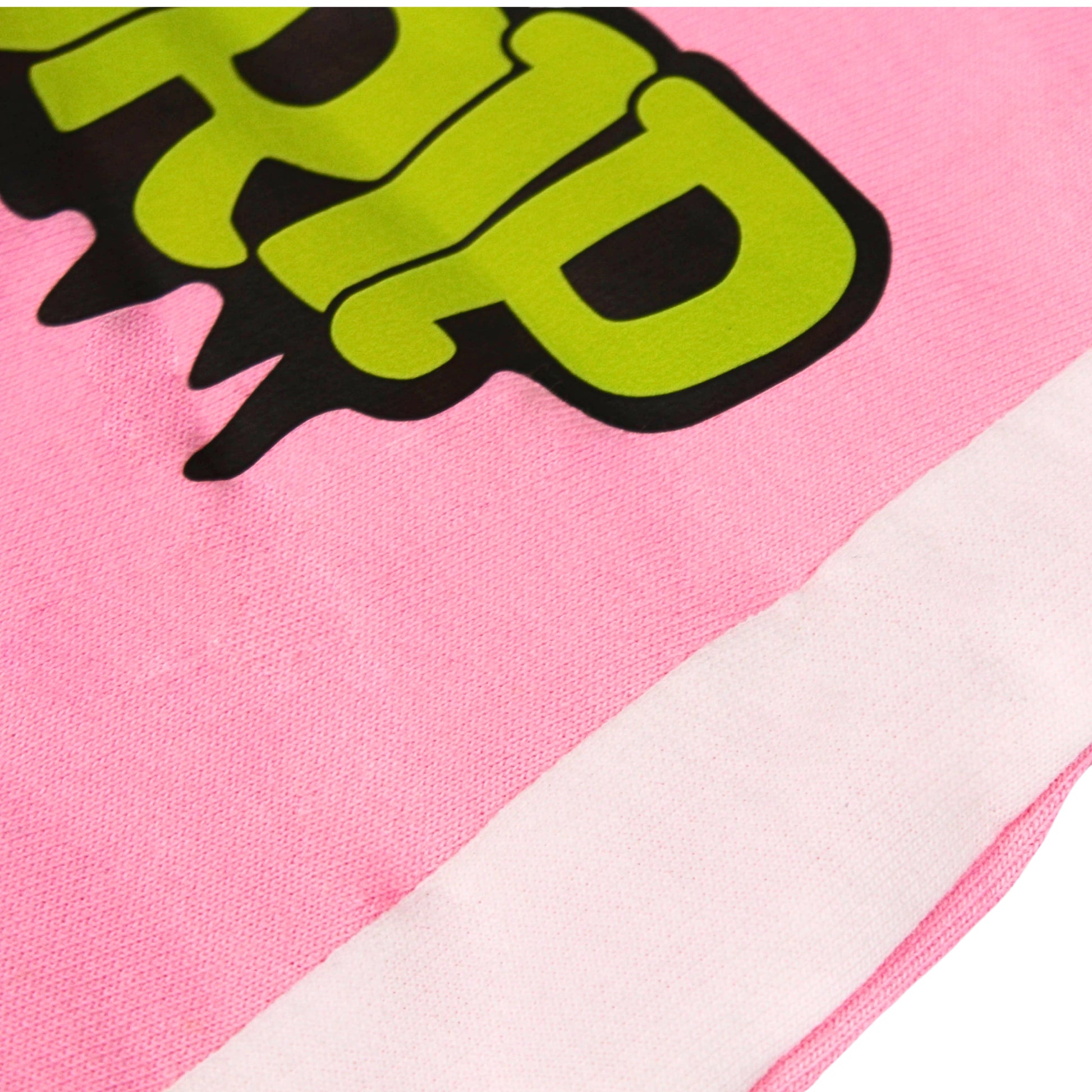 A close-up image of a Babydrip garment featuring pink terry cotton fabric with a large lime green and black graphic print and a white diagonal stripe laid out flat on a white background.