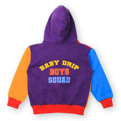 A Babydrip boys color block hooded sweatshirt shown from the back, featuring a purple body with orange sleeve on the left, blue sleeve on the right, and a red ribbed hem and cuffs. The back is printed with 'BABY DRIP BOYS SQUAD' in yellow, orange, and blue lettering at the center of the back. The hooded sweatshirt is laid out on a white background.