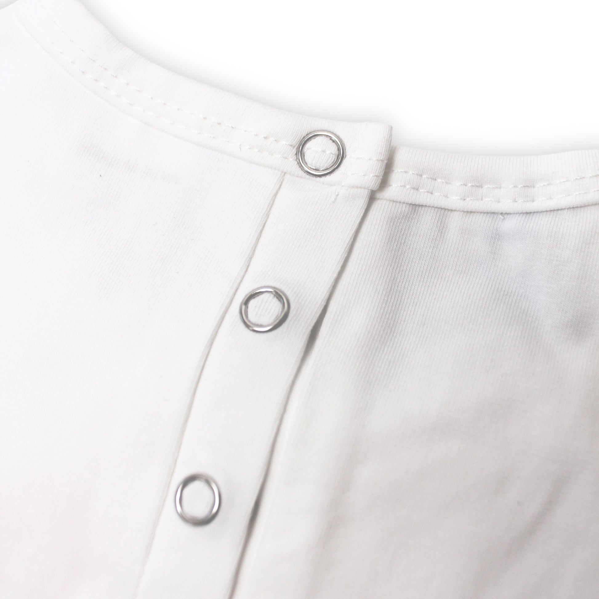 Close-up image of a white shirt with snap open and shut button details on a white background.